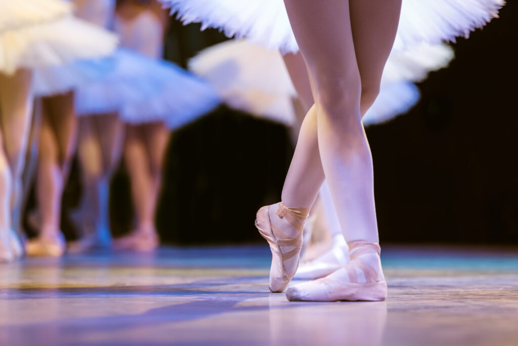 Programs legs of ballerinas dancing in ballet swan lake.